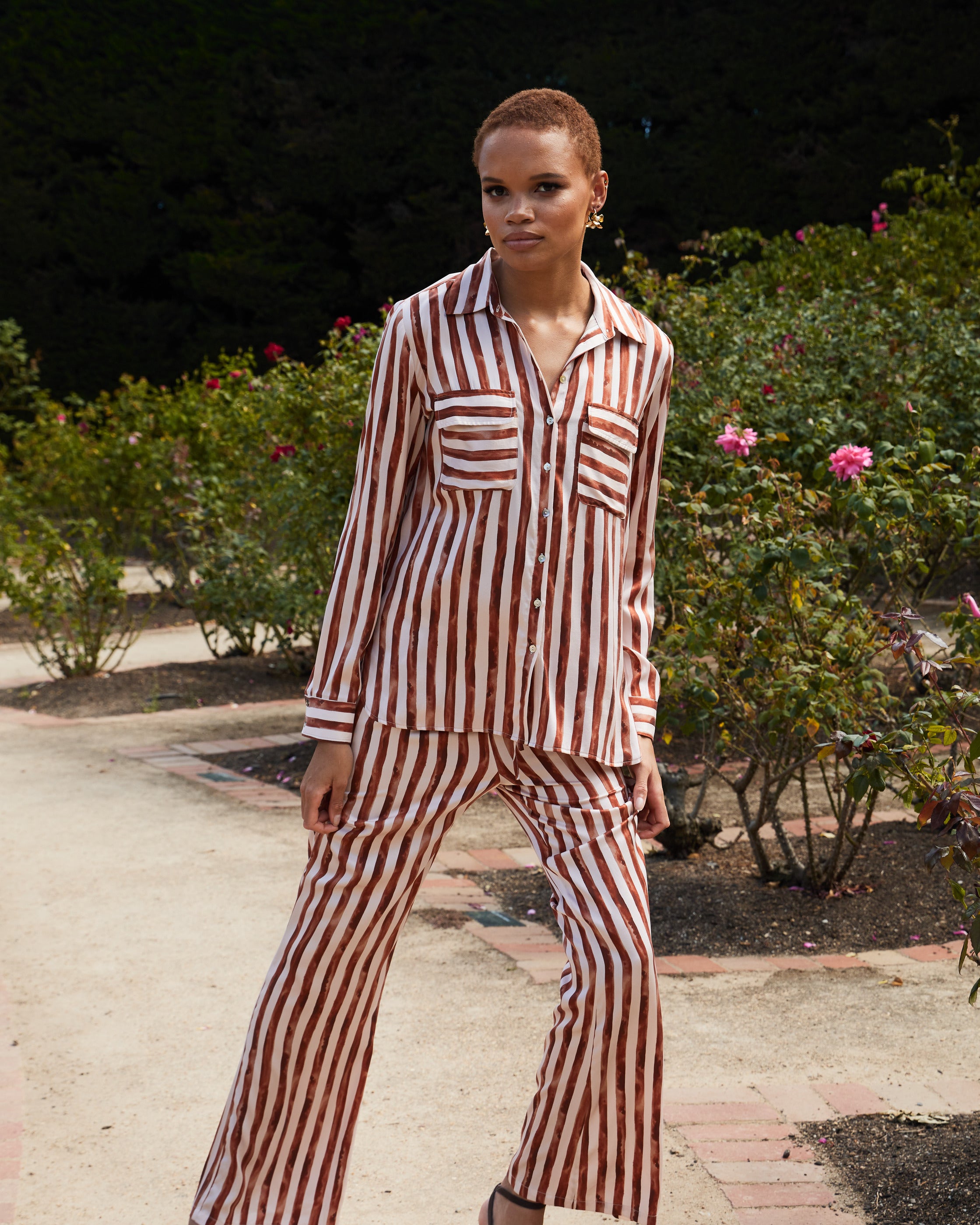 striped silk shirt and pants on woman in a park 