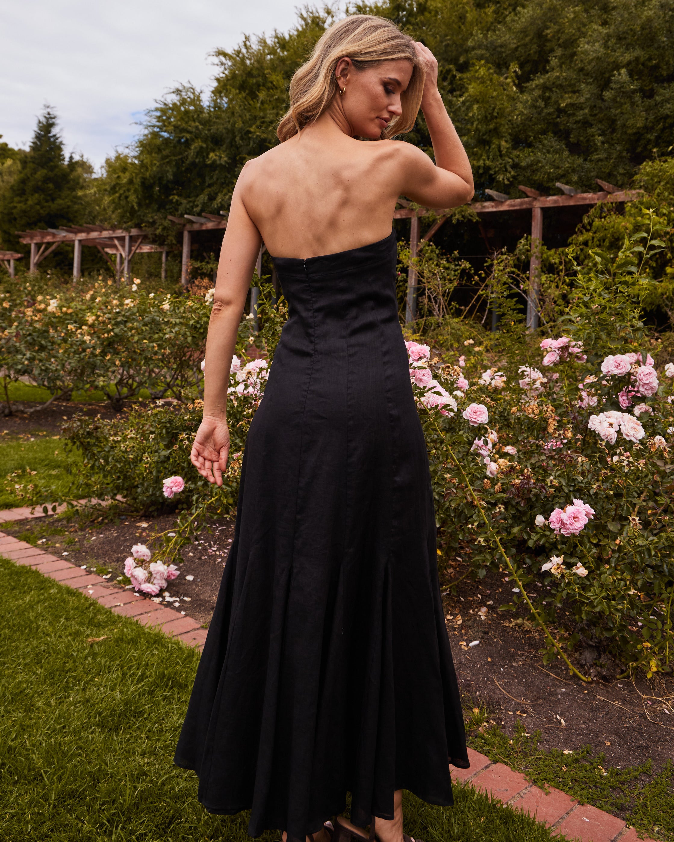 woman wearing black strapless dress back 