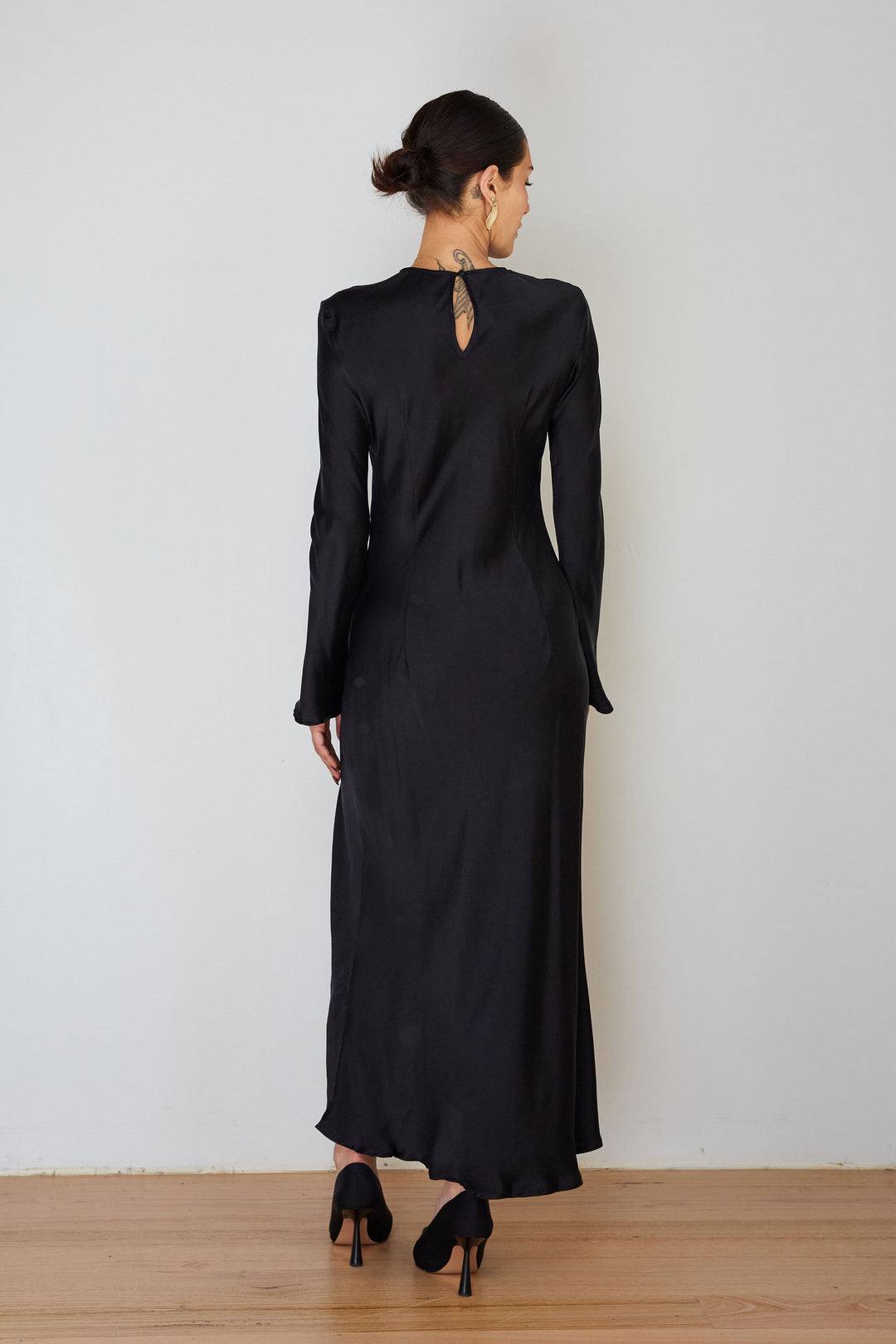 Model wearing the Monument Dress by Ralf Studios in plain Black 