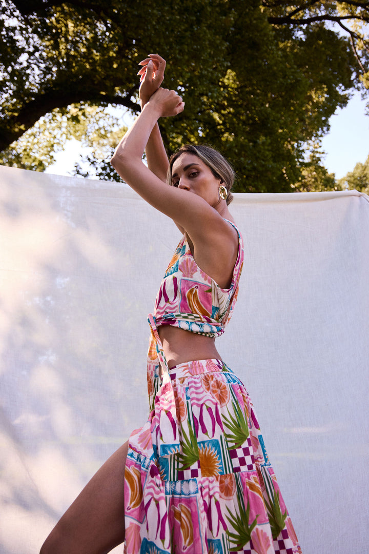 Woman in a colorful outfit posing outdoors with trees in the background