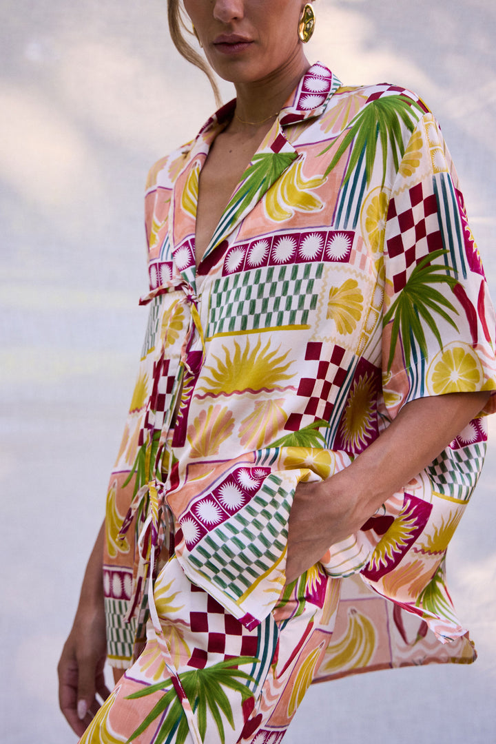 Person wearing a colorful patterned dress with a blurred background